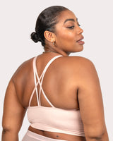 Seamless wireless longline bra in blushing rose, angled back view with crisscross straps