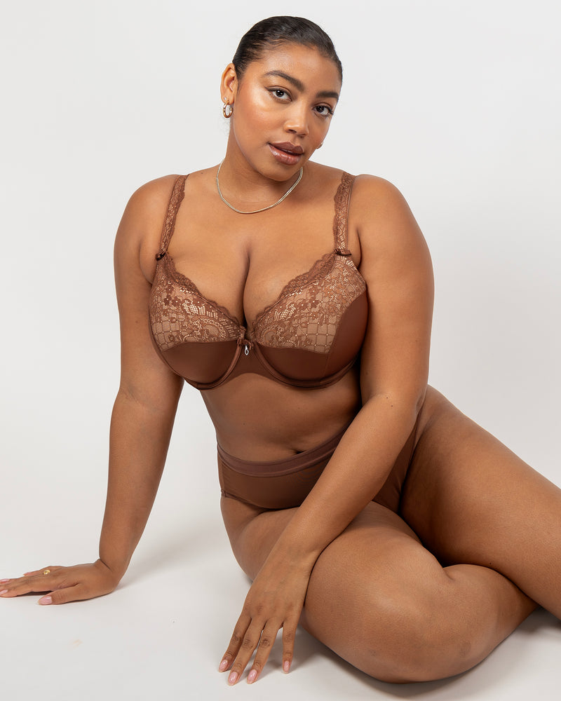Woman wearing a brown lace lingerie set on a white background