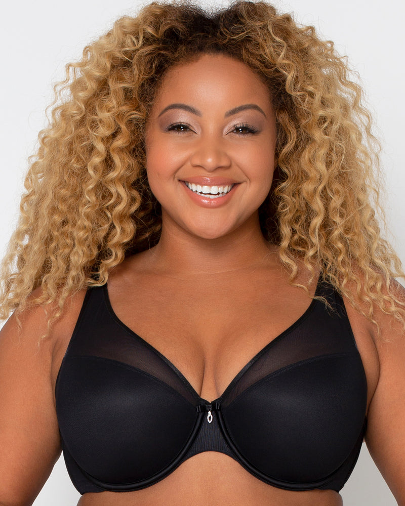 Fotografia do Stock: natural big sexy breasts in a black bra close-up
